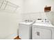 Laundry room features a washer, dryer, storage shelves, and wood-look flooring at 7337 Wythe Dr, Noblesville, IN 46062