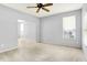 Spacious living room with ceiling fan, large window, and neutral carpet at 7337 Wythe Dr, Noblesville, IN 46062