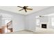 Spacious living room with ceiling fan, fireplace, and views into the foyer and living room at 7337 Wythe Dr, Noblesville, IN 46062