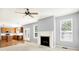 Spacious living room featuring a fireplace and an adjacent kitchen with wood cabinets and stainless steel appliances at 7337 Wythe Dr, Noblesville, IN 46062