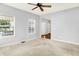 Large living room with natural light, ceiling fan, and neutral gray walls at 7337 Wythe Dr, Noblesville, IN 46062