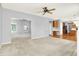 Open-concept living area with neutral walls, carpet and ceiling fan, flowing into kitchen area at 7337 Wythe Dr, Noblesville, IN 46062