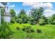 Sprawling backyard with lush green grass and mature trees offers a private outdoor oasis at 8038 Sydney Ln, Avon, IN 46123