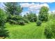 Lush green backyard with mature trees offers plenty of room for outdoor activities at 8038 Sydney Ln, Avon, IN 46123