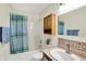 This charming bathroom features a shower with a blue and green shower curtain and decorative mirror cabinet at 8038 Sydney Ln, Avon, IN 46123