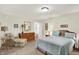 This spacious bedroom features a comfortable bed, dresser, and inviting sitting area with soft, natural light at 8038 Sydney Ln, Avon, IN 46123