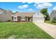 Charming single Gathering home with brick facade, two-car garage and well-manicured lawn on a sunny day at 8038 Sydney Ln, Avon, IN 46123
