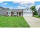 Charming one-story home featuring a manicured lawn, brick facade, and an attached two car garage at 8038 Sydney Ln, Avon, IN 46123