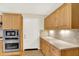 A kitchen featuring stainless steel appliances, tiled backsplash and wooden cabinets at 8038 Sydney Ln, Avon, IN 46123