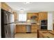 Updated kitchen with stainless steel appliances, tiled backsplash, and ample cabinet space at 8038 Sydney Ln, Avon, IN 46123