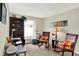 A bright office/den features a desk, decorative rocking chairs, and a large window with plenty of natural light at 8038 Sydney Ln, Avon, IN 46123