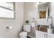 Powder room featuring modern fixtures, a stainless steel sink, and a neutral color palette at 8117 Scarborough Ct, Indianapolis, IN 46256