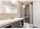 Modern bathroom featuring a glass shower, geometric tile accent wall, and stylish vanity at 8117 Scarborough Ct, Indianapolis, IN 46256
