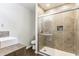Modern bathroom featuring a walk-in shower with decorative tile accent and wood-look floors at 8117 Scarborough Ct, Indianapolis, IN 46256