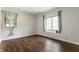 Bright bedroom with wood-look flooring and natural light from two windows at 8117 Scarborough Ct, Indianapolis, IN 46256