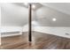 Bonus room with wood-look flooring, a support beam and painted in white at 8117 Scarborough Ct, Indianapolis, IN 46256