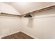 Walk-in closet featuring rods for hanging clothes and new flooring at 8117 Scarborough Ct, Indianapolis, IN 46256