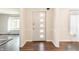 Bright foyer featuring wood floors, a front door with decorative windows, and views of the living areas at 8117 Scarborough Ct, Indianapolis, IN 46256