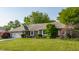 Charming brick ranch home featuring a well-manicured lawn, mature landscaping, and an attached two-car garage at 8117 Scarborough Ct, Indianapolis, IN 46256