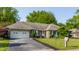 Charming brick ranch home with a well-manicured lawn, an asphalt driveway, and an attached two-car garage at 8117 Scarborough Ct, Indianapolis, IN 46256