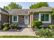 Inviting front entrance with a patterned welcome mat, lush greenery, and brick facade at 8117 Scarborough Ct, Indianapolis, IN 46256