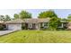 Charming brick home with well-maintained lawn, attached garage, and beautiful landscaping at 8117 Scarborough Ct, Indianapolis, IN 46256