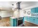 Updated kitchen features stylish blue cabinets, modern appliances, and wood-look floors at 8117 Scarborough Ct, Indianapolis, IN 46256