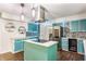 Stylish kitchen features custom blue cabinetry, a center island, and stainless steel appliances at 8117 Scarborough Ct, Indianapolis, IN 46256