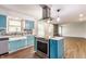 Open-concept kitchen with island cooktop, modern appliances, and hardwood floors flowing into the living space at 8117 Scarborough Ct, Indianapolis, IN 46256