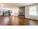 Bright living space merges seamlessly with the kitchen, featuring a fireplace and wood-look flooring at 8117 Scarborough Ct, Indianapolis, IN 46256