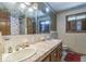 Bathroom featuring double sinks, a large mirror, and ample storage, providing a functional and stylish space at 8217 S Talbott Ave, Indianapolis, IN 46227