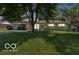 Charming single-story home with a well-maintained lawn and an attached carport showcasing its inviting curb appeal at 8217 S Talbott Ave, Indianapolis, IN 46227