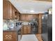 Functional kitchen with wooden cabinets and appliances, offering ample storage and cooking space for culinary enthusiasts at 8217 S Talbott Ave, Indianapolis, IN 46227