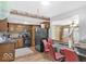 Open kitchen with wooden cabinets and eat-in dining, creating a functional and inviting space with a view into the Gathering room at 8217 S Talbott Ave, Indianapolis, IN 46227
