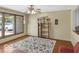 Bright living room featuring hardwood floors, large windows, and a ceiling fan, creating a comfortable and inviting space at 8217 S Talbott Ave, Indianapolis, IN 46227