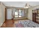 Bright living room featuring wood floors, large windows, and a ceiling fan, creating a comfortable and inviting space at 8217 S Talbott Ave, Indianapolis, IN 46227