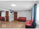 Spacious living room with bright windows, featuring hardwood floors and neutral paint, perfect for relaxation and entertainment at 8217 S Talbott Ave, Indianapolis, IN 46227