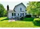 The home has an outdoor patio featuring outdoor furniture, mature trees, and a well-manicured lawn at 8460 Brittany N Ct, Indianapolis, IN 46236