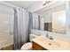 Bathroom featuring a vanity and toilet in front of shower with patterned curtain at 8460 Brittany N Ct, Indianapolis, IN 46236