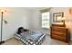 This carpeted bedroom features a bed, a window, a chest of drawers, and natural lighting at 8460 Brittany N Ct, Indianapolis, IN 46236
