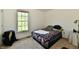 Bedroom boasts ample natural light from a large window, a bed, and bedside table at 8460 Brittany N Ct, Indianapolis, IN 46236