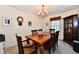 The dining room is well-lit with a traditional chandelier and includes a large wooden table with seating for six at 8460 Brittany N Ct, Indianapolis, IN 46236