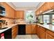 This kitchen features wooden cabinets, granite countertops, and black appliances, providing functionality and style at 8460 Brittany N Ct, Indianapolis, IN 46236
