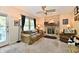 A cozy living room with a fireplace, neutral carpeting, and comfortable seating invites relaxation at 8460 Brittany N Ct, Indianapolis, IN 46236