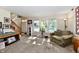A neutral-toned living room features bright windows, soft furniture, and stairs leading up to the next level at 8460 Brittany N Ct, Indianapolis, IN 46236