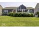 Backyard features a lush lawn, a deck, and well-maintained landscaping around the house's perimeter at 8864 S Tibbs Ave, Indianapolis, IN 46217