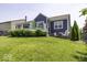 Well-maintained backyard featuring a lush green lawn and a house with a deck and landscaping at 8864 S Tibbs Ave, Indianapolis, IN 46217