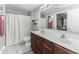 The bathroom features a double sink vanity and a shower with a curtain for convenience at 8864 S Tibbs Ave, Indianapolis, IN 46217