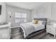 Sunlit bedroom featuring neutral decor, wood-look floors, and a comfortable bed, creating a cozy atmosphere at 8864 S Tibbs Ave, Indianapolis, IN 46217