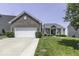 Charming brick home featuring a well-manicured lawn and a spacious two-car garage, perfect for suburban living at 8864 S Tibbs Ave, Indianapolis, IN 46217